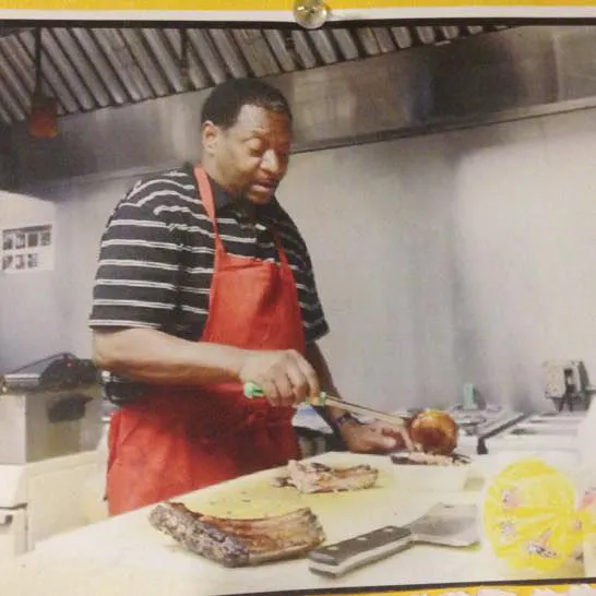 Pitmaster and owner James Massengill slicing smoked ribs on the cutting board at Chatt Smokehouse